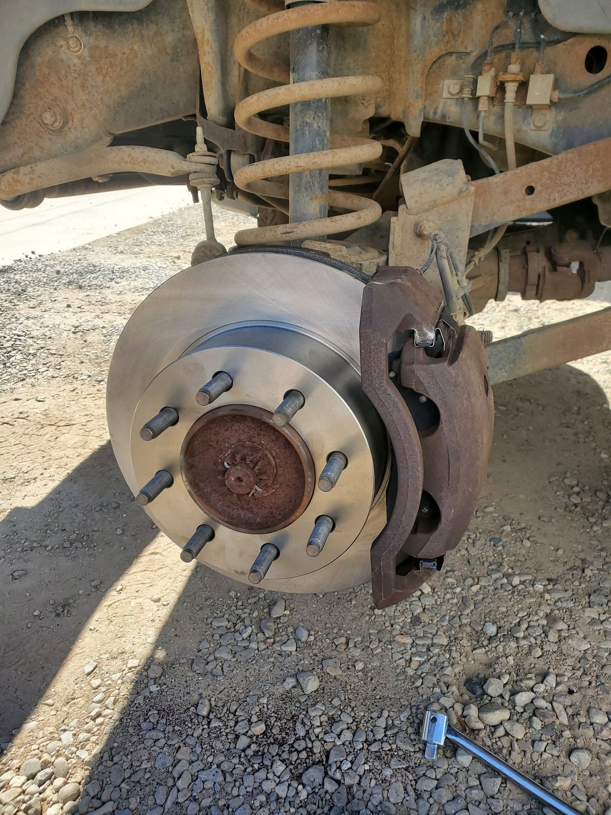 New front brake rotor and caliper on a 2007 Ram 2500 in Ventura