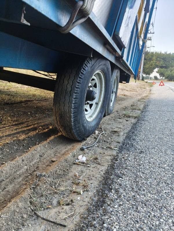 Tandem-axle trailer parked on a road shoulder