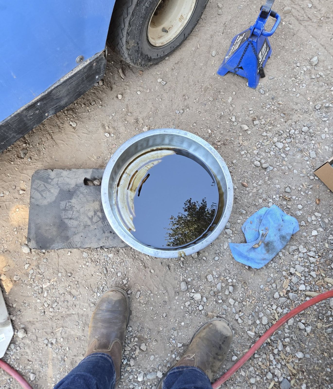 Drain pan full of dark used oil from a Yamaha golf cart service in Ojai